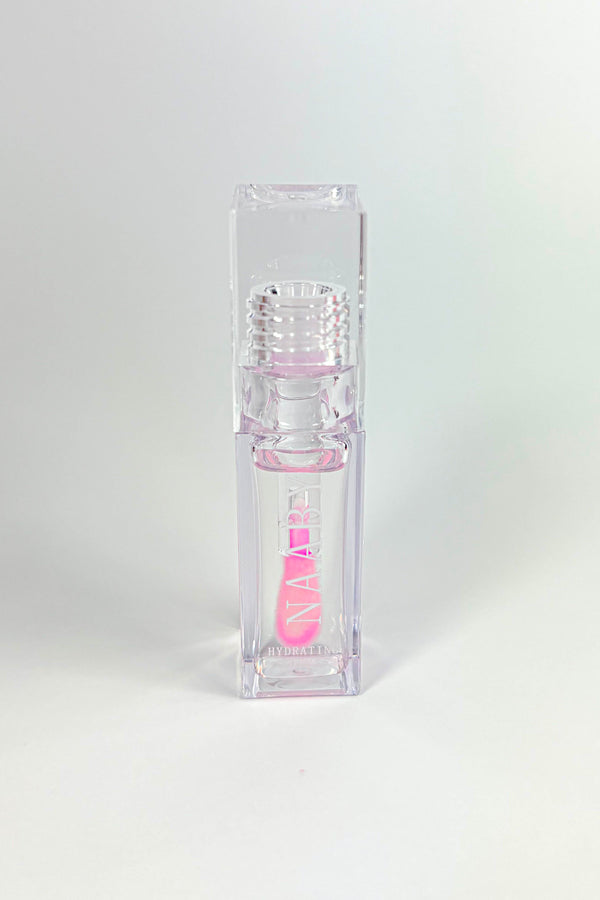 Clear lip gloss container with pink interior on a white background-Bleeding Heart color changing lip oil