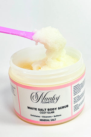 Jar of white salt body scrub with a pink spoon, branded as 'Naaby Cosmetics'.