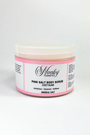 Jar of pink salt body scrub with a white label on a white background.Cozy Glam – Pink Salt Body Scrub