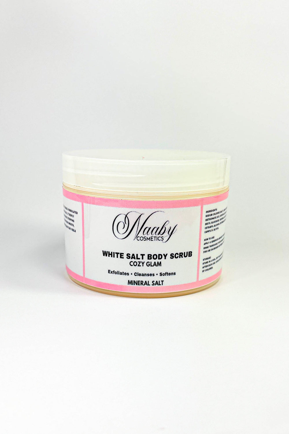 Jar of white salt body scrub with pink label on a white background.Cozy Glam – White  Salt Body Scrub