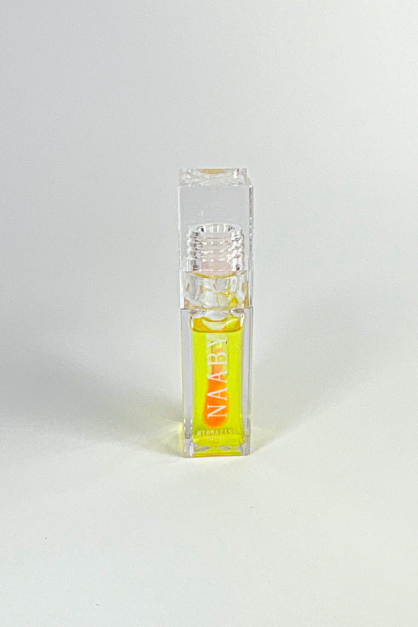 Small clear bottle with yellow liquid labeled 'NAABY' on a white background-Golden Glow color changing lip oil