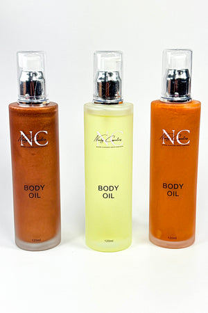 Three bottles of body oil with 'Naaby Cosmetics' branding on a white background.Naaby Cosmetics  Body Oils