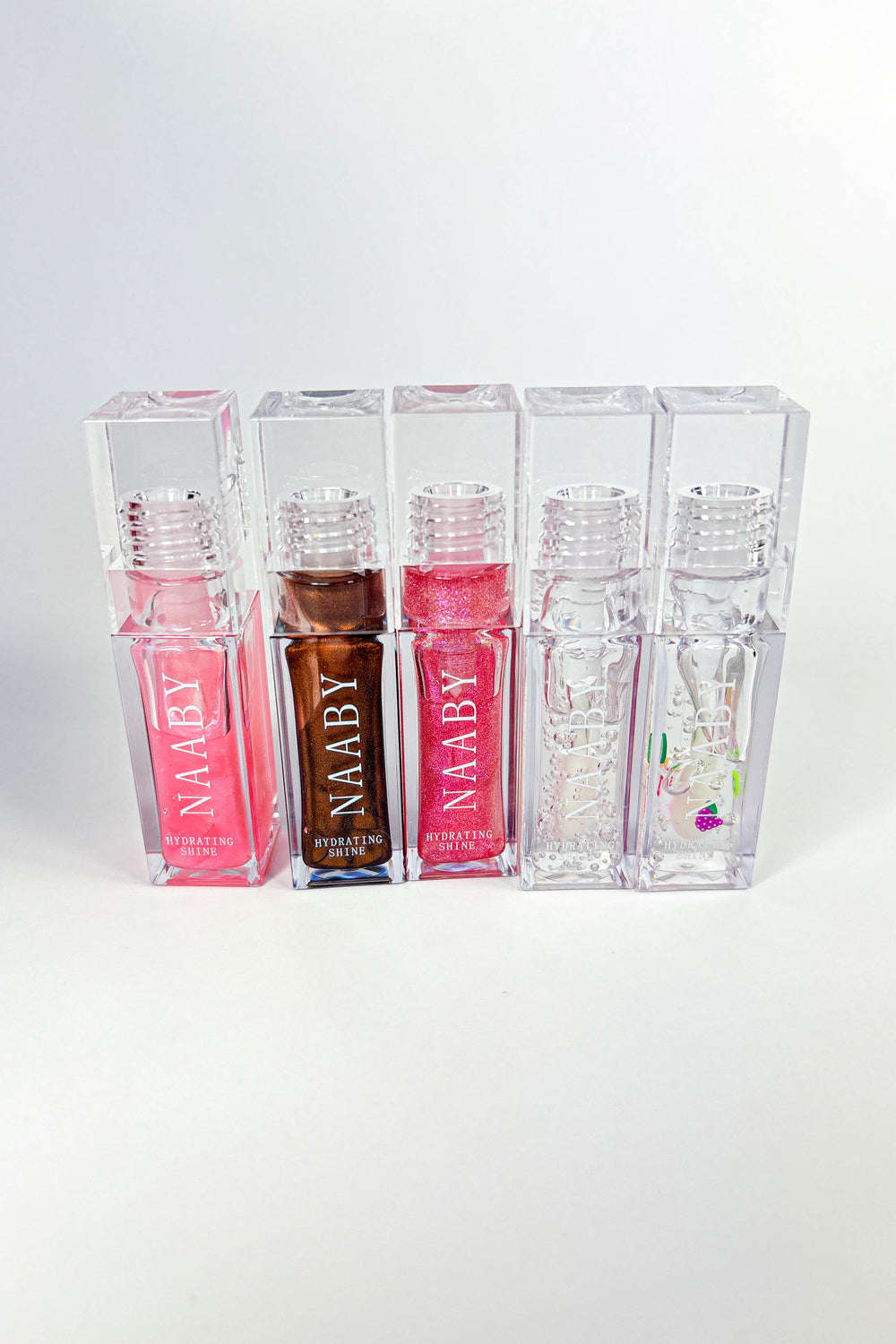 Pink lip gloss with 'NAABY' branding on a white background-Cinnamon Bun  Long-Lasting Hydrating Lip Gloss