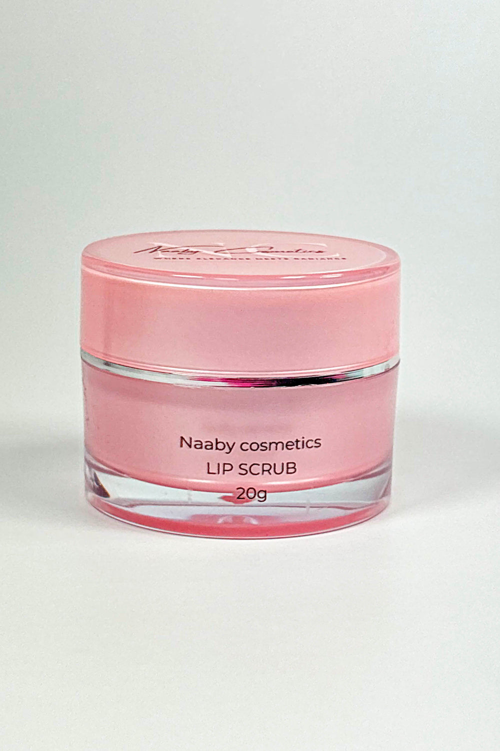 Cosmetic cream in a clear container with a pink lid on a white background.lemon Sugar Lip Scrub – Natural Lip Exfoliator for Soft, Smooth Lips