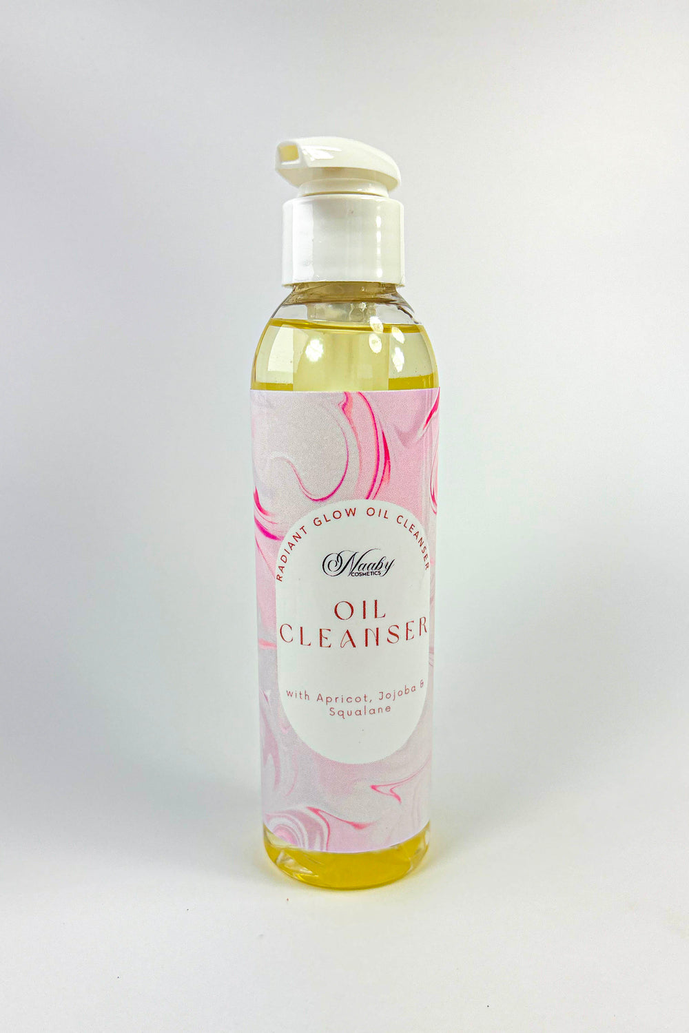 Bottle of oil cleanser with a floral label on a white background
