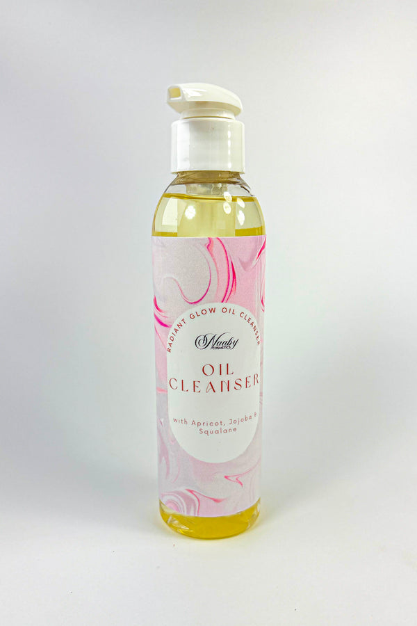 Bottle of oil cleanser with a floral label on a white background