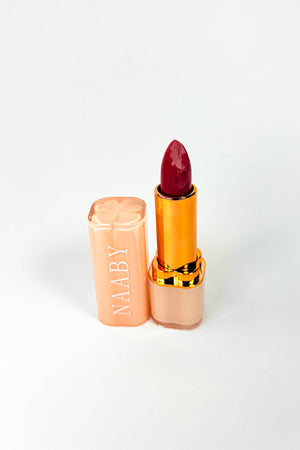 Naaby Cosmetics Lipstick with gold and beige casing on a white background