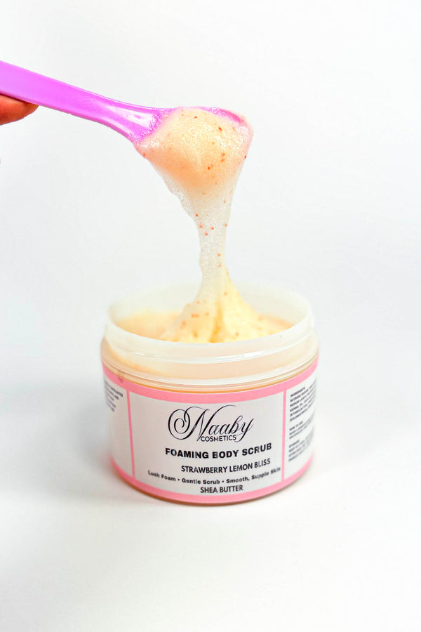 Jar of foaming body scrub with pink spoon lifting a scoop of scrub.Strawberry Lemon Bliss – Foaming Sugar Body Scrub