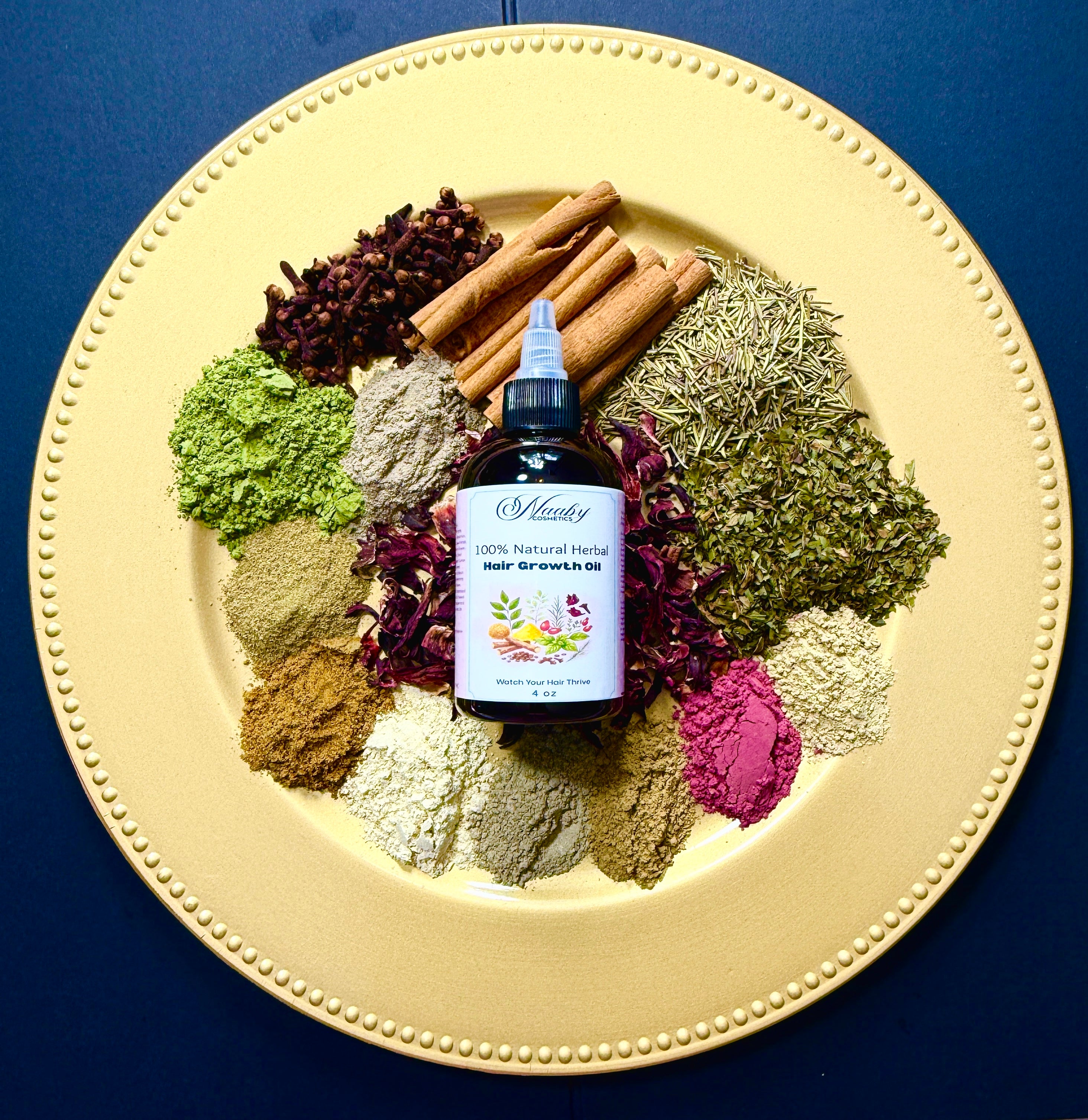 Bottle of hair growth oil surrounded by dried herbs and spices on a decorative plate.