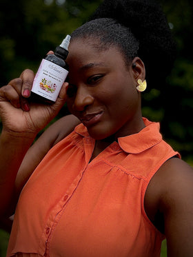 Woman holding a bottle of natural product outdoors