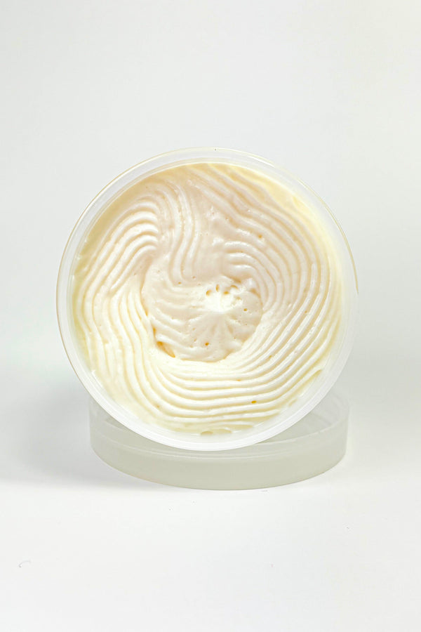 Creamy white dessert in a clear container on a white background. Naaby Strawberry Lemon Bliss – Whipped Body Butter